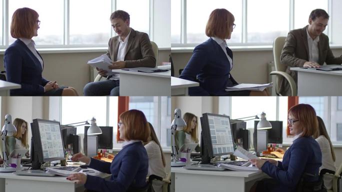 截瘫女商人与同事交谈并在计算机上打字