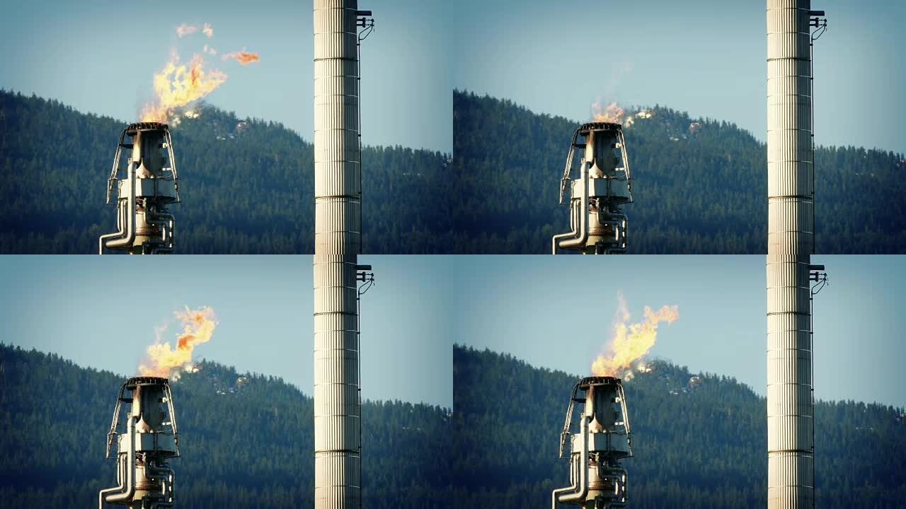 巨大的炼油厂管道产生的气体火焰