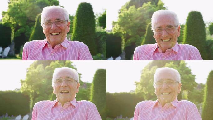 快乐的老人在花园里对着镜头微笑