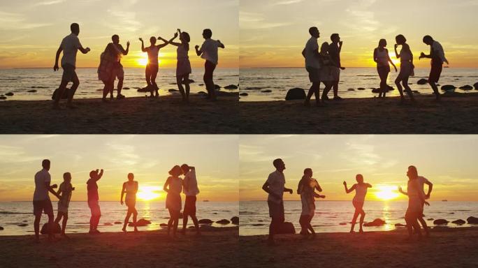一群年轻人在日落的沙滩上跳舞