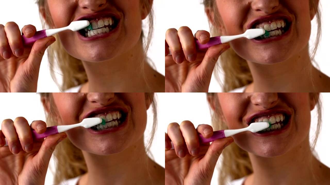 女人在白色背景上刷牙