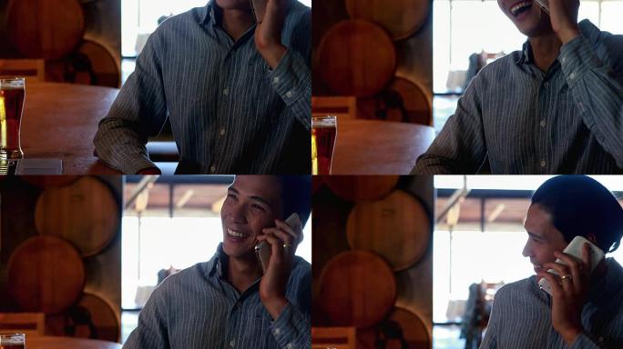 男子在4k餐厅用手机聊天时喝啤酒