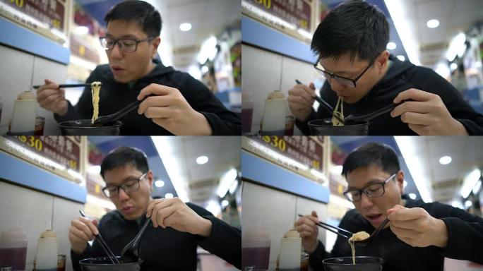 亚洲男子吃香港馄饨虾面汤
