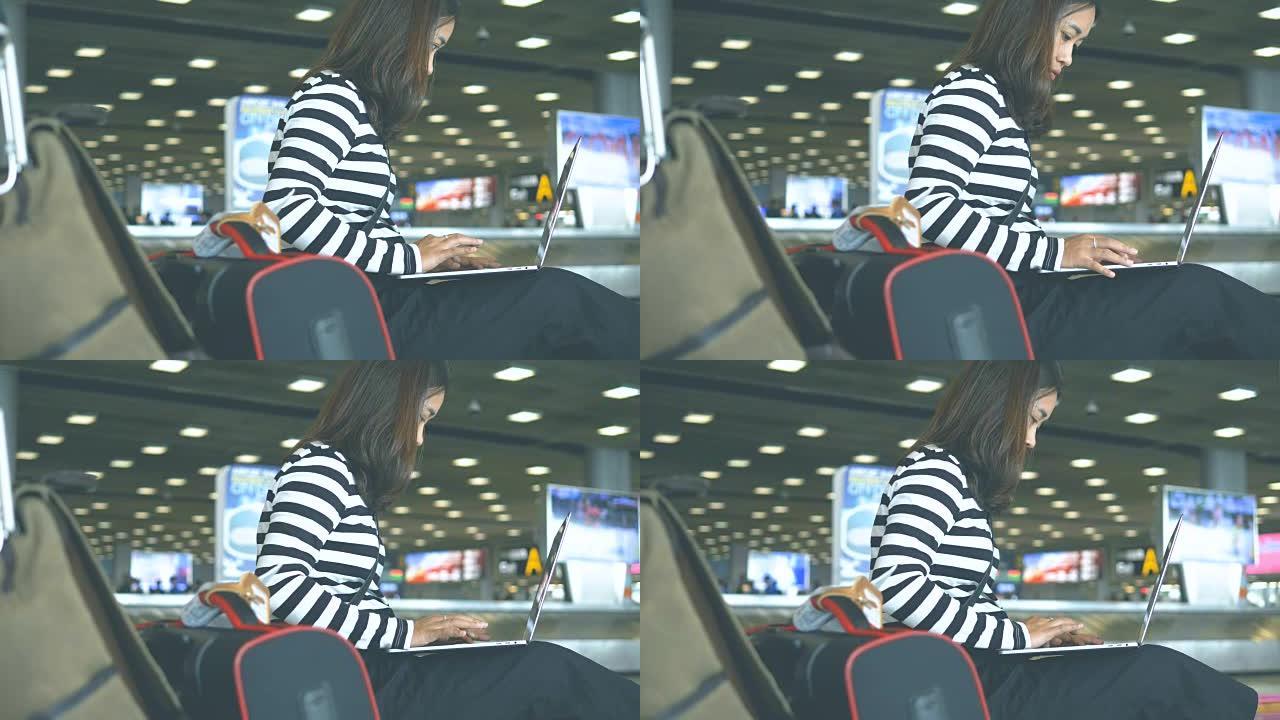 忙碌: 亚洲妇女在出发航站楼机场使用笔记本电脑