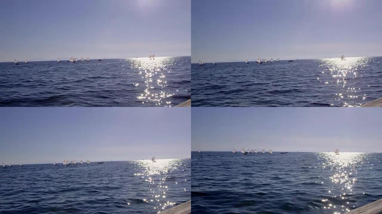 4k小艇和帆船在阳光明媚的蓝色海洋上，实时