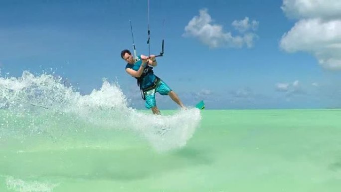 慢动作:快乐的极端风筝跳跃和溅水水滴到摄像机