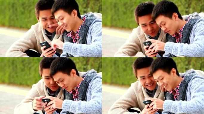 两名年轻男子一起使用手机的视频
