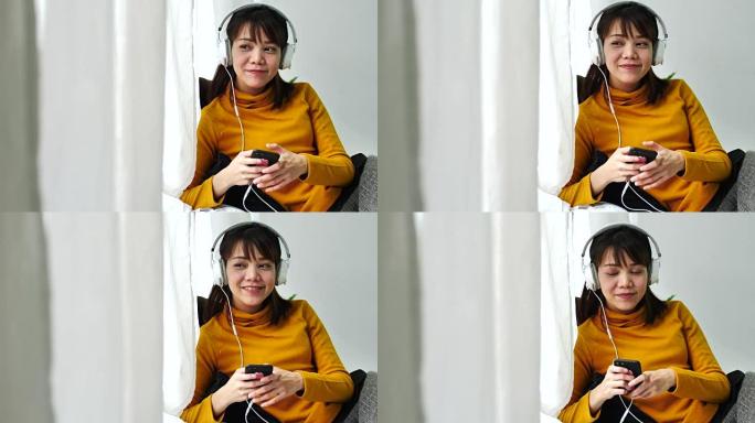 一名年轻女子戴着耳机听音乐的慢动作场景