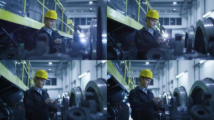 安全帽技术人员在工业环境中使用手机。