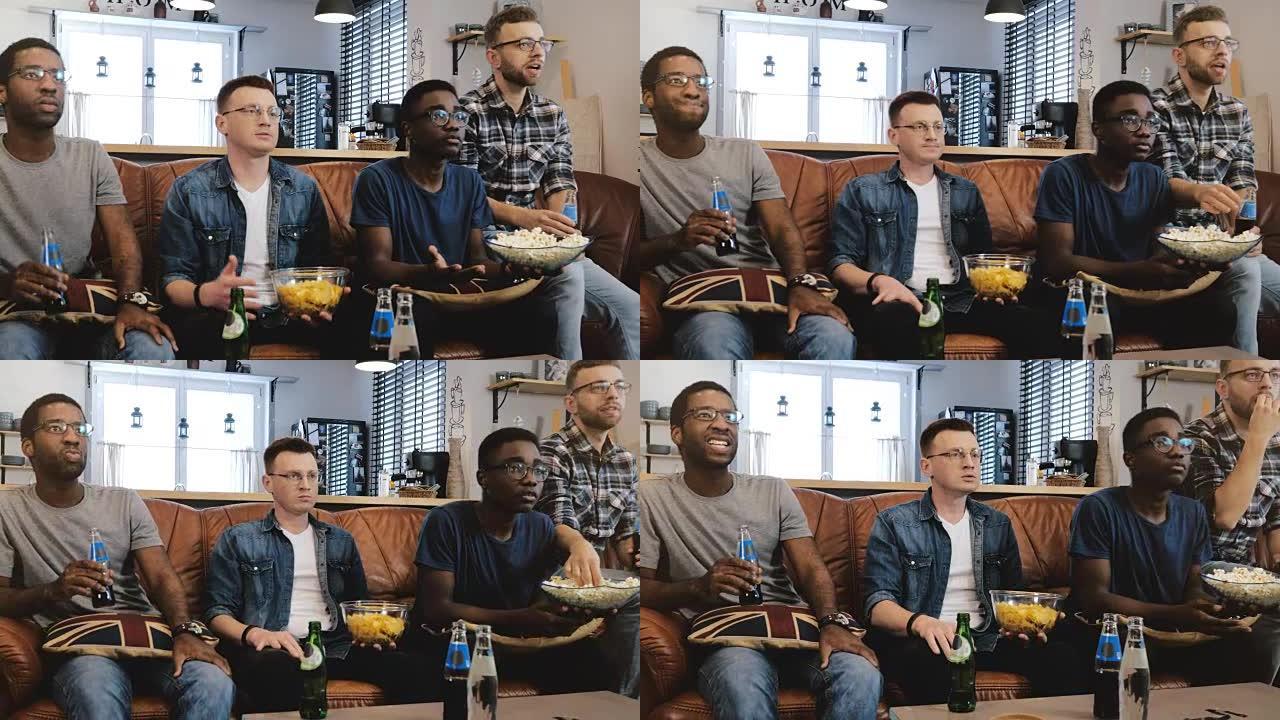 非裔美国男性朋友在电视上观看体育节目。多民族极客迷集中在爆米花的沙发上