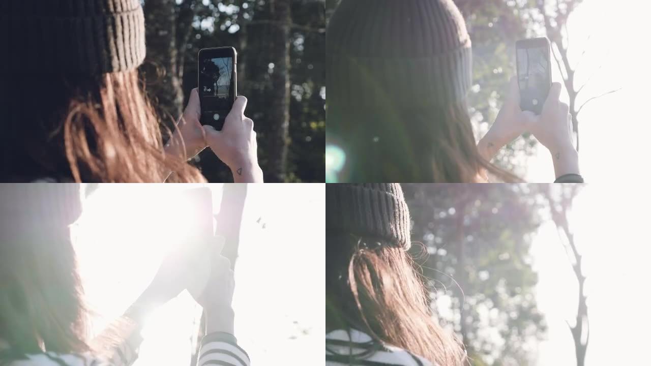女性游客使用智能手机拍摄全景照片。