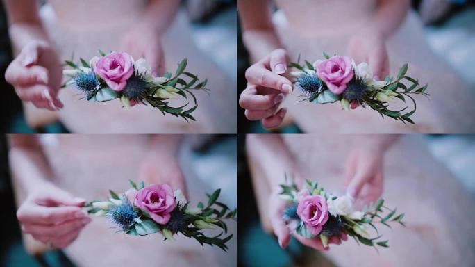 花匠女人手里拿着花的特写镜头。女孩触摸美丽的扣眼