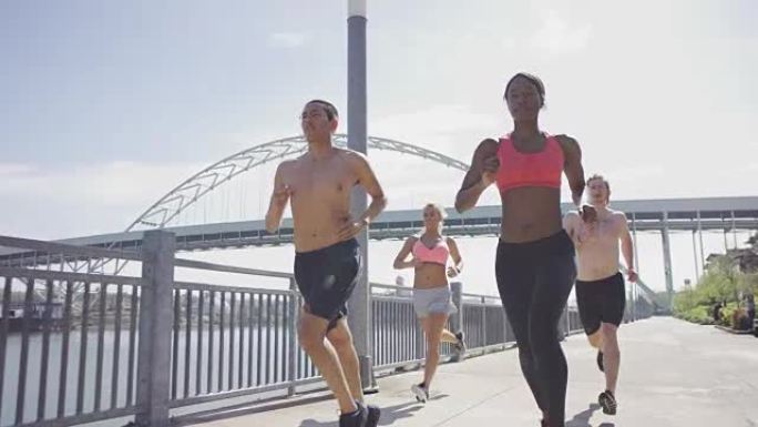 一群年轻的成年跑步者在海滨城市奔跑