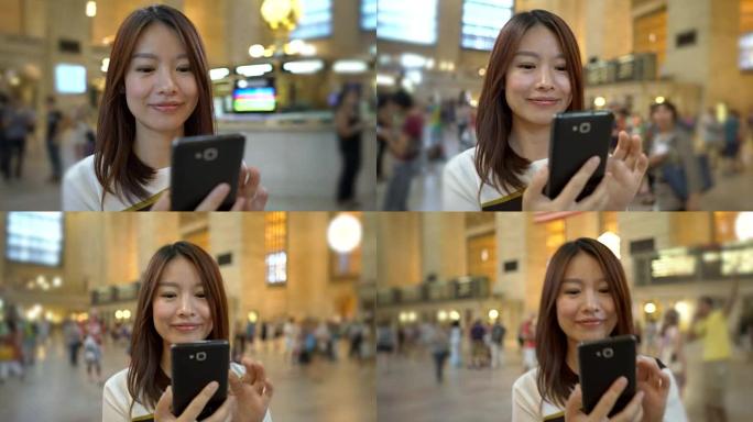 英俊的中国女人在城市里发短信和打电话。快乐，微笑，开心。