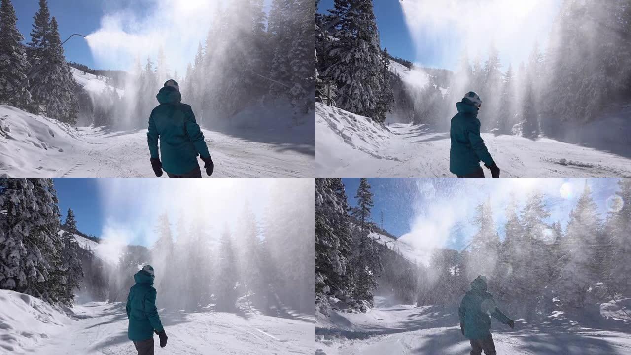 慢动作: 女子滑雪板在雪枪下喷洒人造雪
