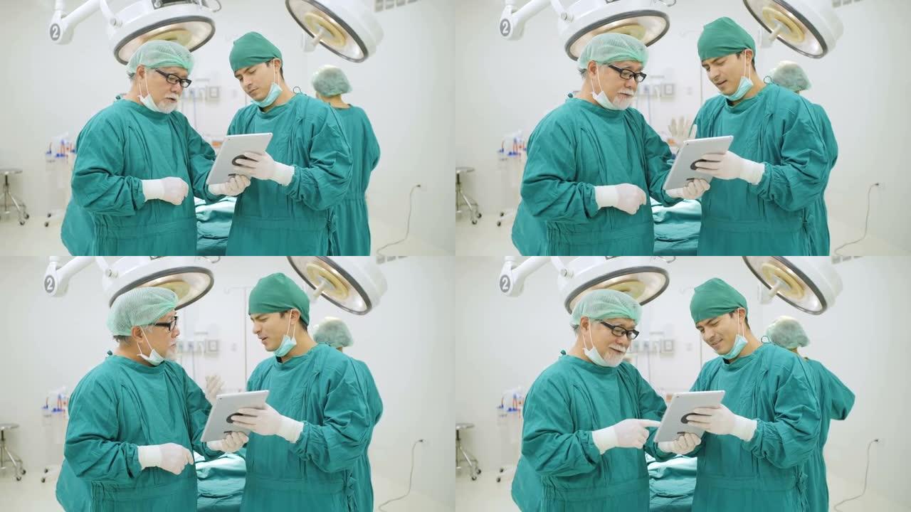 两名外科医生在医院手术室使用数字平板电脑读取患者的病史。
