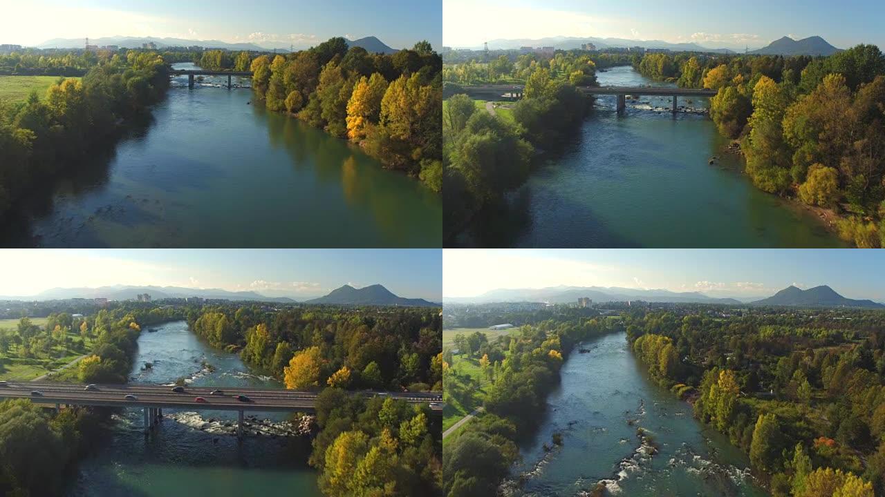 空中: 美丽的绿色宽阔的河流贯穿郊区小镇