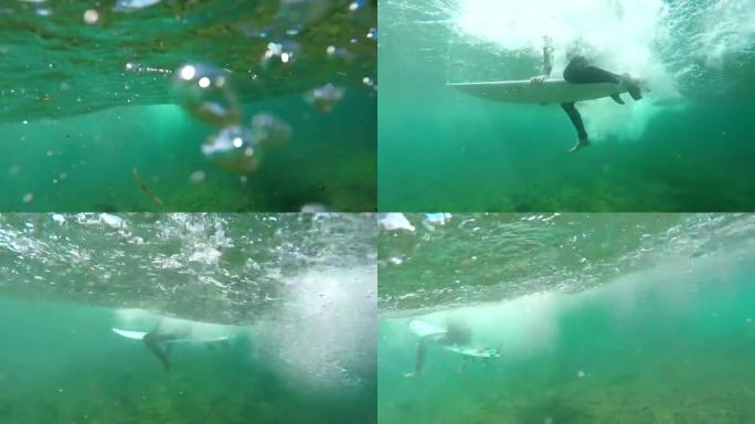 水下慢动作: 冲浪者在清澈的大西洋中划桨