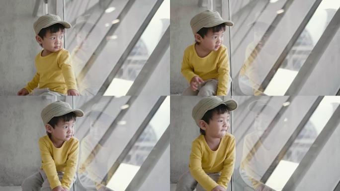 亚洲儿童在机场等待飞行时间