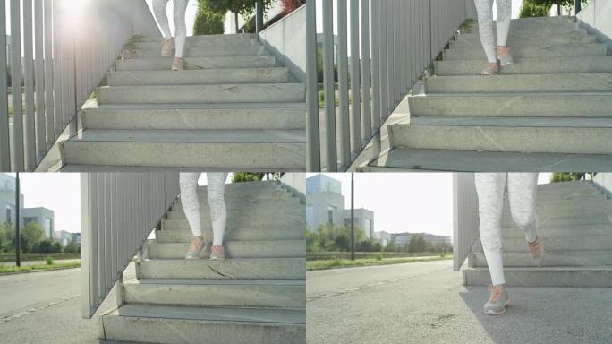 慢动作: 穿着白色衣服的未知健康女孩早上从水泥楼梯上跑下来。