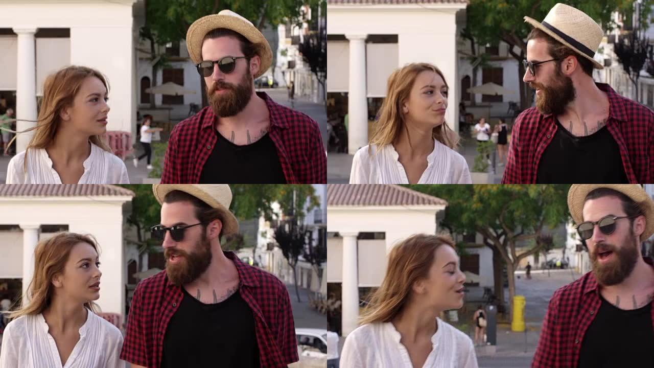 在R3D上拍摄的度假夫妇在穿越伊比沙岛镇时聊天
