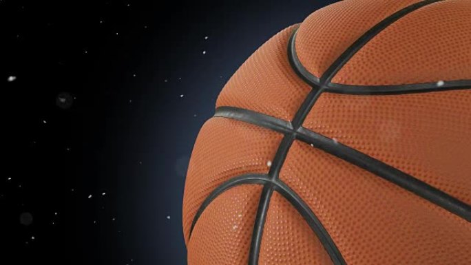美丽的篮球旋转特写镜头在黑色上慢动作，尘埃颗粒飞扬。回环篮球3d动画的转球。4k UHD 3840x