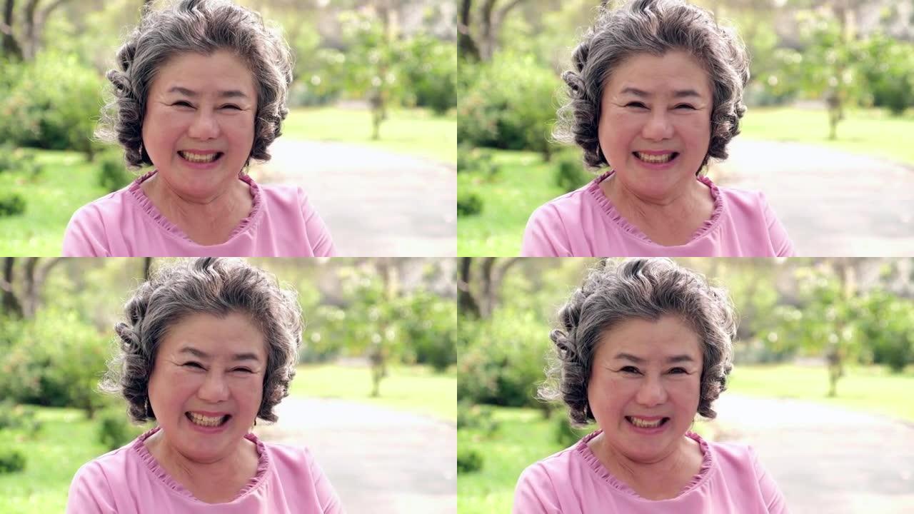 亚洲高级女性肖像。高级肖像，快乐的老妇人微笑着看着相机
