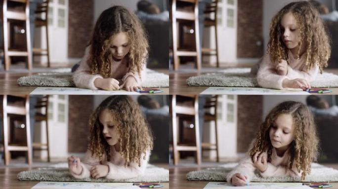 Little girl lying on the floor and drawing
