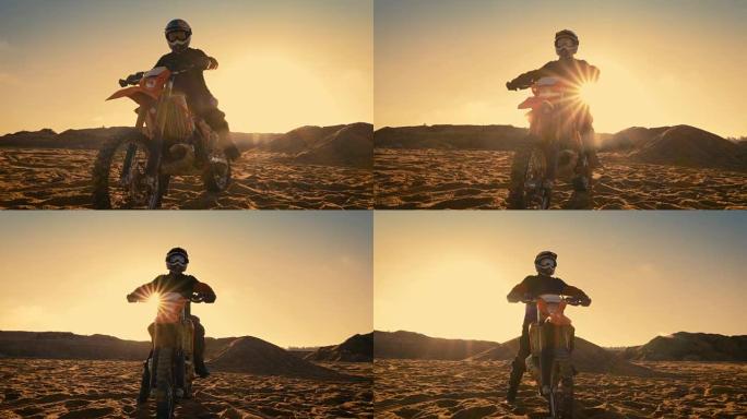 低角度拍摄的职业摩托车越野赛摩托车骑手站在道路上的越野。这是《日落》，赛道上布满了烟雾。