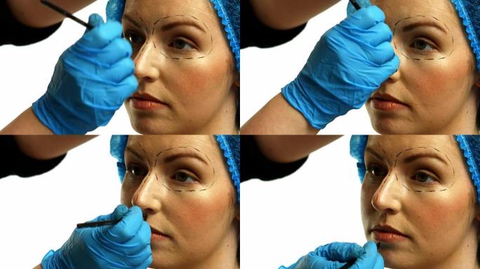 整形外科医生在女人脸上做标记