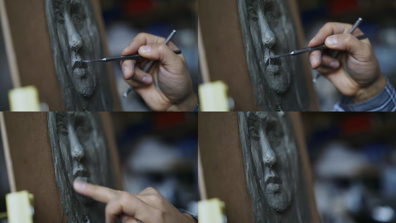雕塑家在艺术工作室的画布上创作人脸雕塑的特写