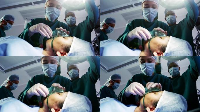 外科医生在手术室给病人戴上氧气面罩