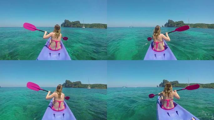 特写: 年轻的女游客在美丽的翡翠海周围划皮艇。