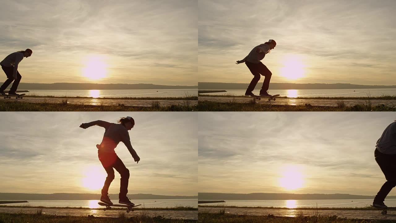 慢动作滑板手在夕阳上滑冰和跳跃踢脚技巧