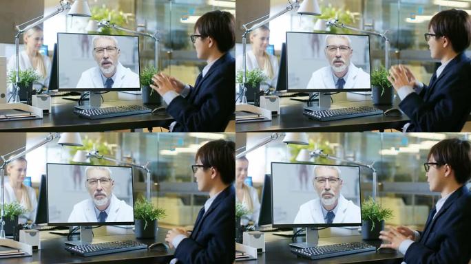 在办公室里，商人与他的医生谈论用个人电脑进行的视频通话。高级医师向东亚商人咨询并撰写说明。