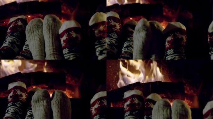 4k舒适的脚穿着圣诞袜，在舒适的壁炉旁放松，慢动作
