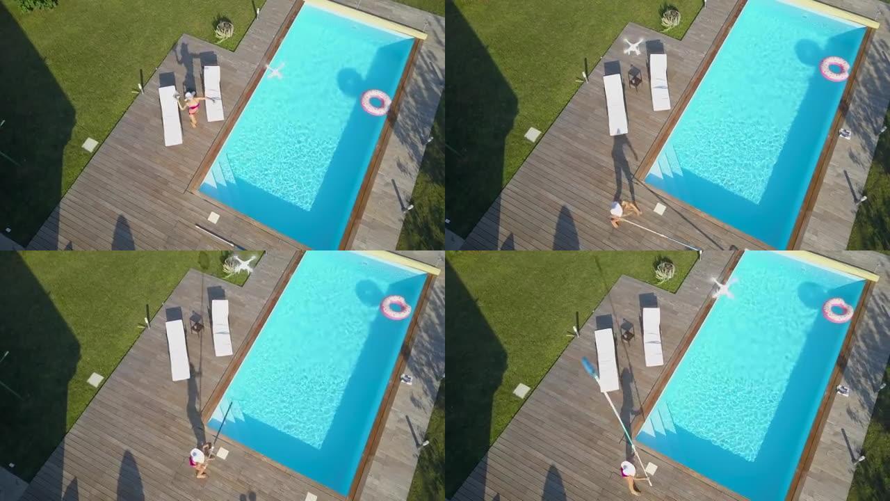 一名躺在泳池边的女子对无人侦察机感到愤怒，并试图将其击落