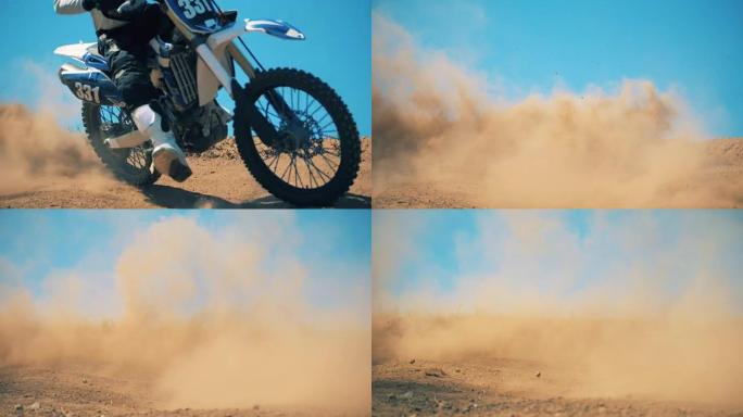 摩托车驶过地形后，尘土飞扬。
