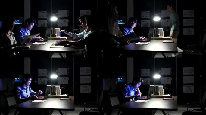 商人晚上在办公室使用计算机。一个年轻的混血儿晚上在笔记本电脑上看起来很累，但继续工作。疲倦的商人在晚