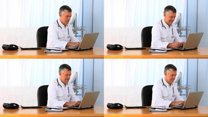 忙碌的医生在笔记本电脑上工作