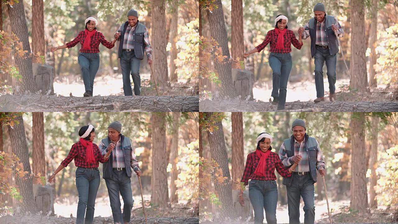 高级黑人夫妇在森林中徒步旅行，前视图