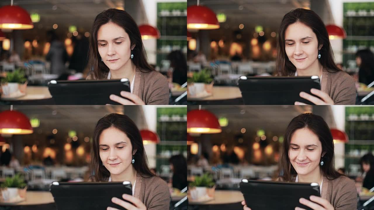 咖啡馆里使用平板电脑的女人