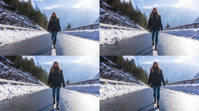 冬天，年轻女子在山腰的一座桥上行走