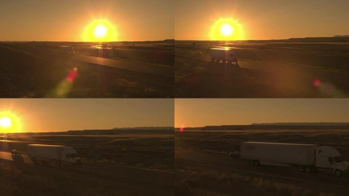 空中卡车，汽车和suv在日落时分穿越平原草木国家