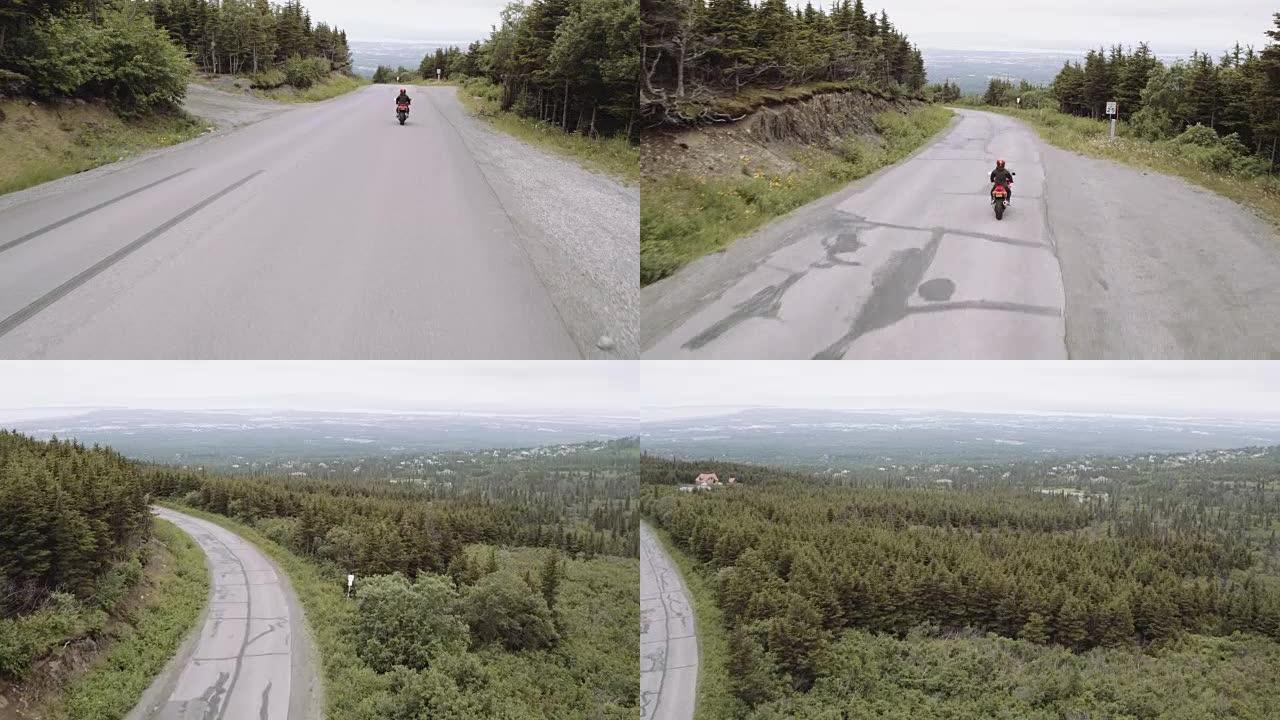 超高清4K天线:一个骑摩托车的人在乡村公路上兜风