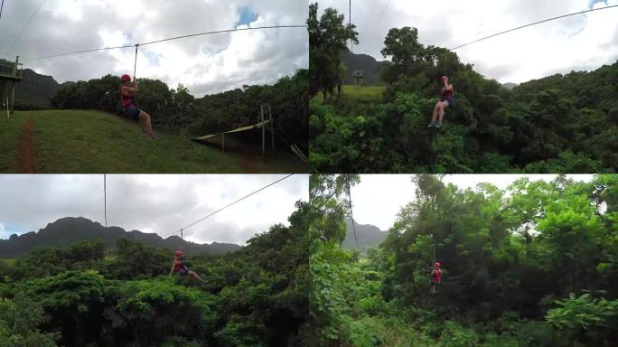 年轻快乐的女孩在茂密的丛林雨林檐篷上方的电缆上滑行