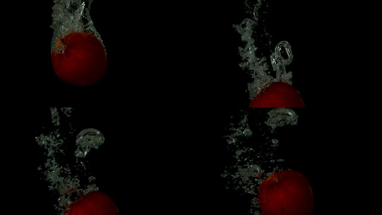 红苹果在黑色背景下陷入水中