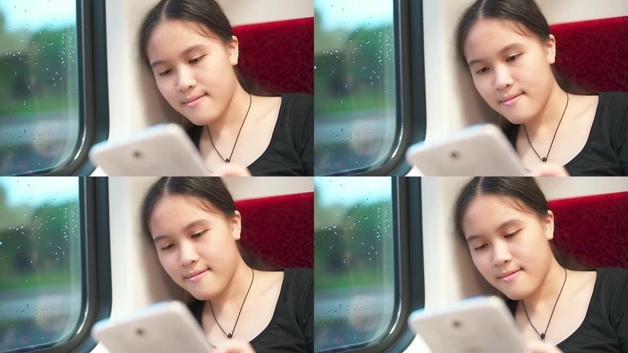 小女孩在火车上使用平板电脑