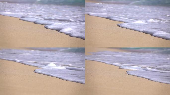 慢动作宏观: 水晶般清澈的海浪泡沫浸泡白色沙滩