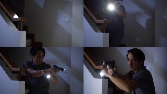 4k家庭防御概念，亚洲男子晚上手持手枪和手电筒。